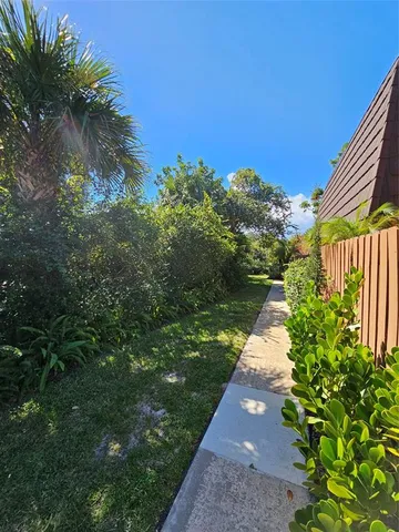 a view of a pathway with a yard