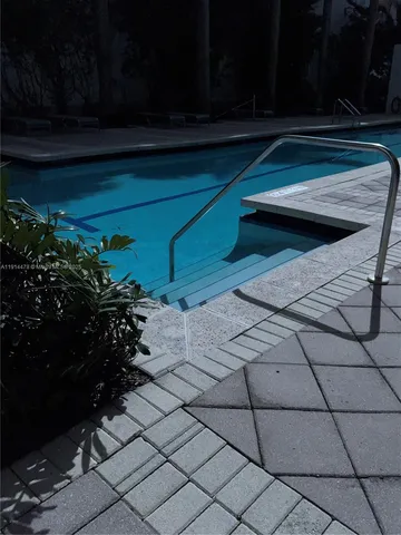 a front view of a house with a yard and a fountain
