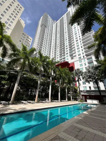 a view of a building with a yard and sitting area