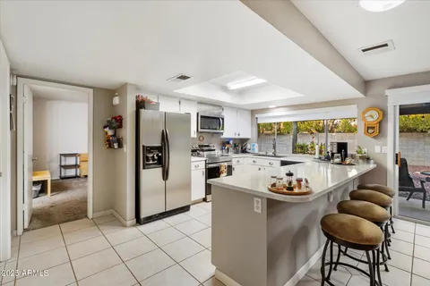 a kitchen with stainless steel appliances kitchen island granite countertop a sink and cabinets
