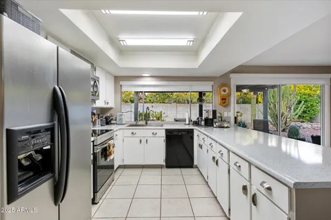 a kitchen with a refrigerator and a stove top oven