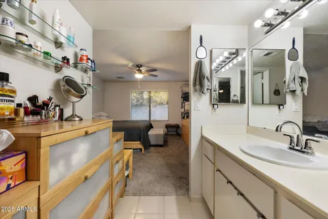 a bathroom with a sink shower and a mirror