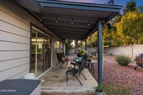 a view of a porch with dining table and chairs