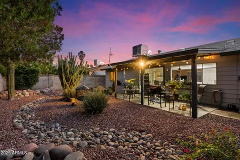 a view of a porch with furniture and garden