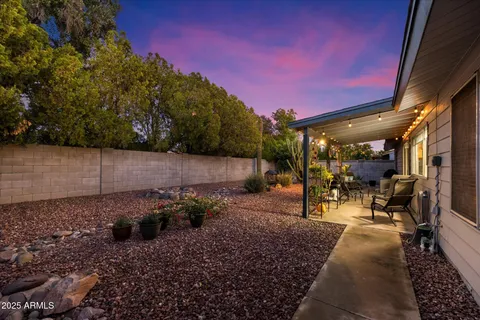 a view of a chairs and table in backyard