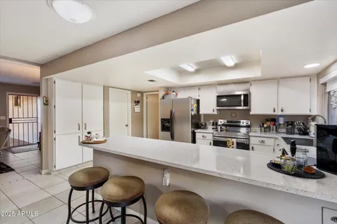 a view of a dining room and livingroom with furniture window and outside view