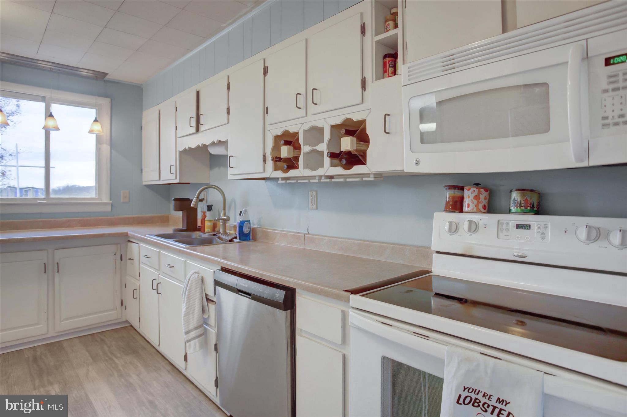 2688 Rocky Spring Road Chambersburg, PA 17201 - Photo 13 of 36 a kitchen with cabinets appliances a sink and a window