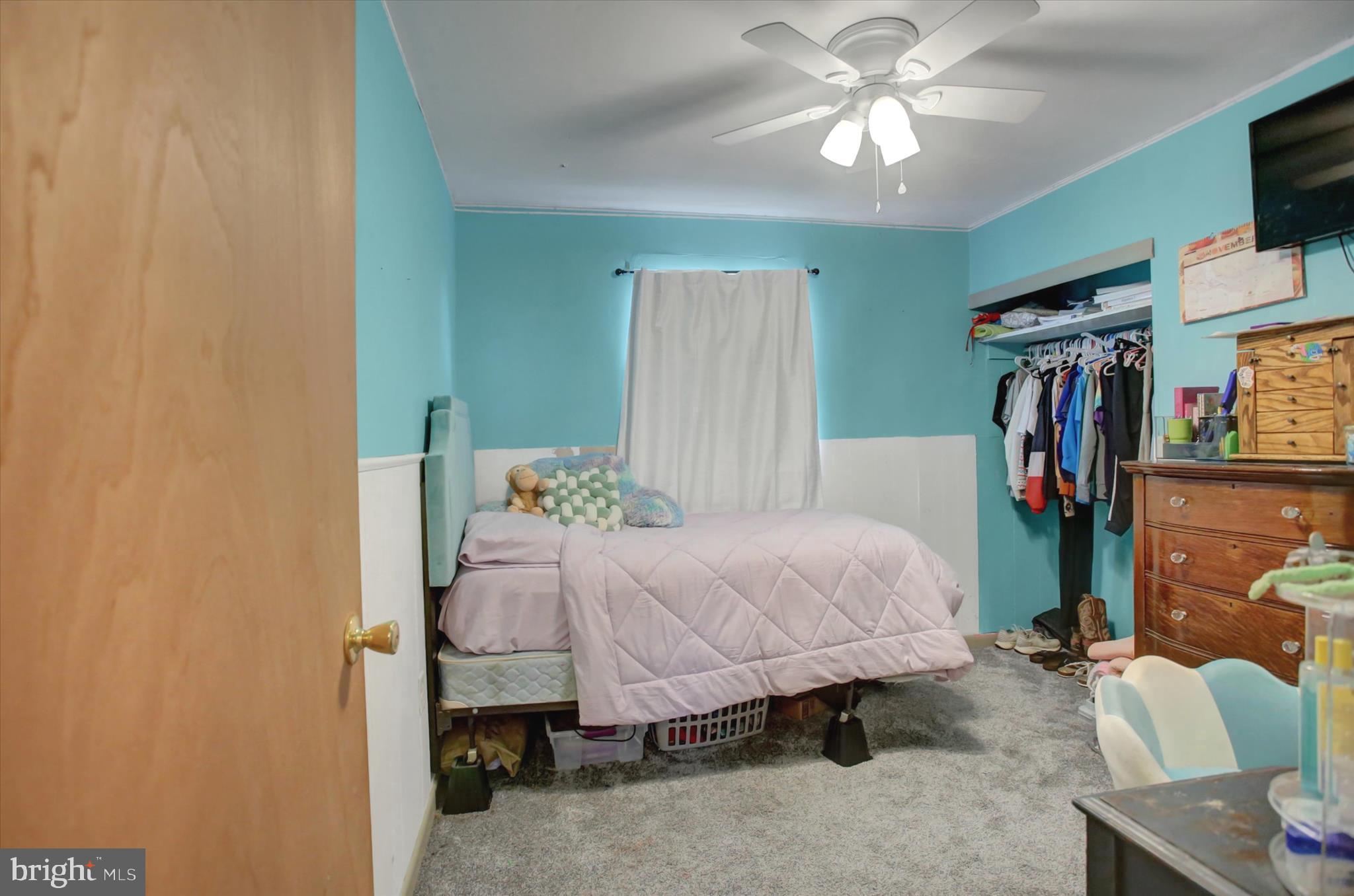 2688 Rocky Spring Road Chambersburg, PA 17201 - Photo 14 of 36 a bedroom with a bed and a chandelier