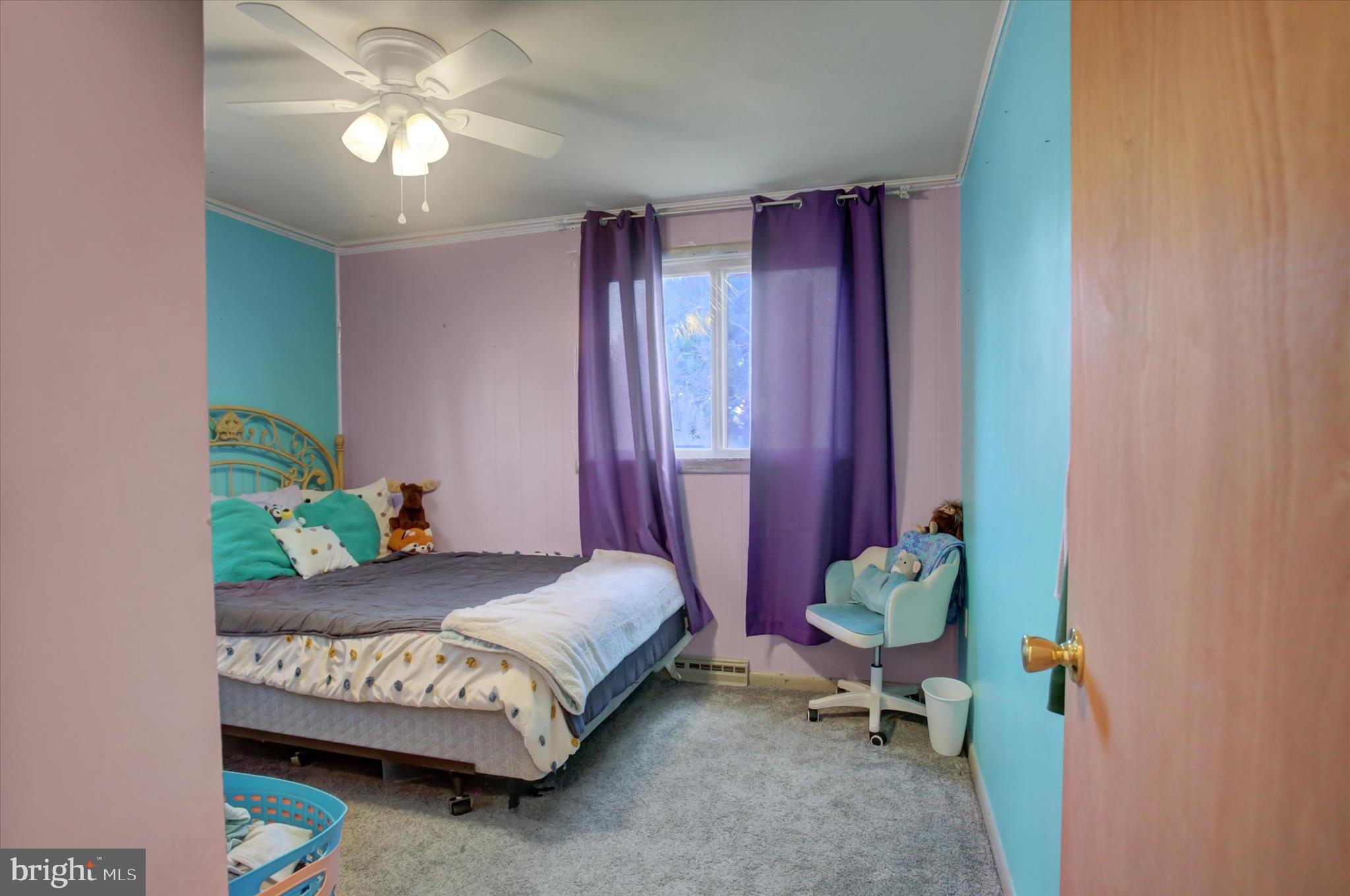 2688 Rocky Spring Road Chambersburg, PA 17201 - Photo 18 of 36 a bedroom with a bed and a chandelier