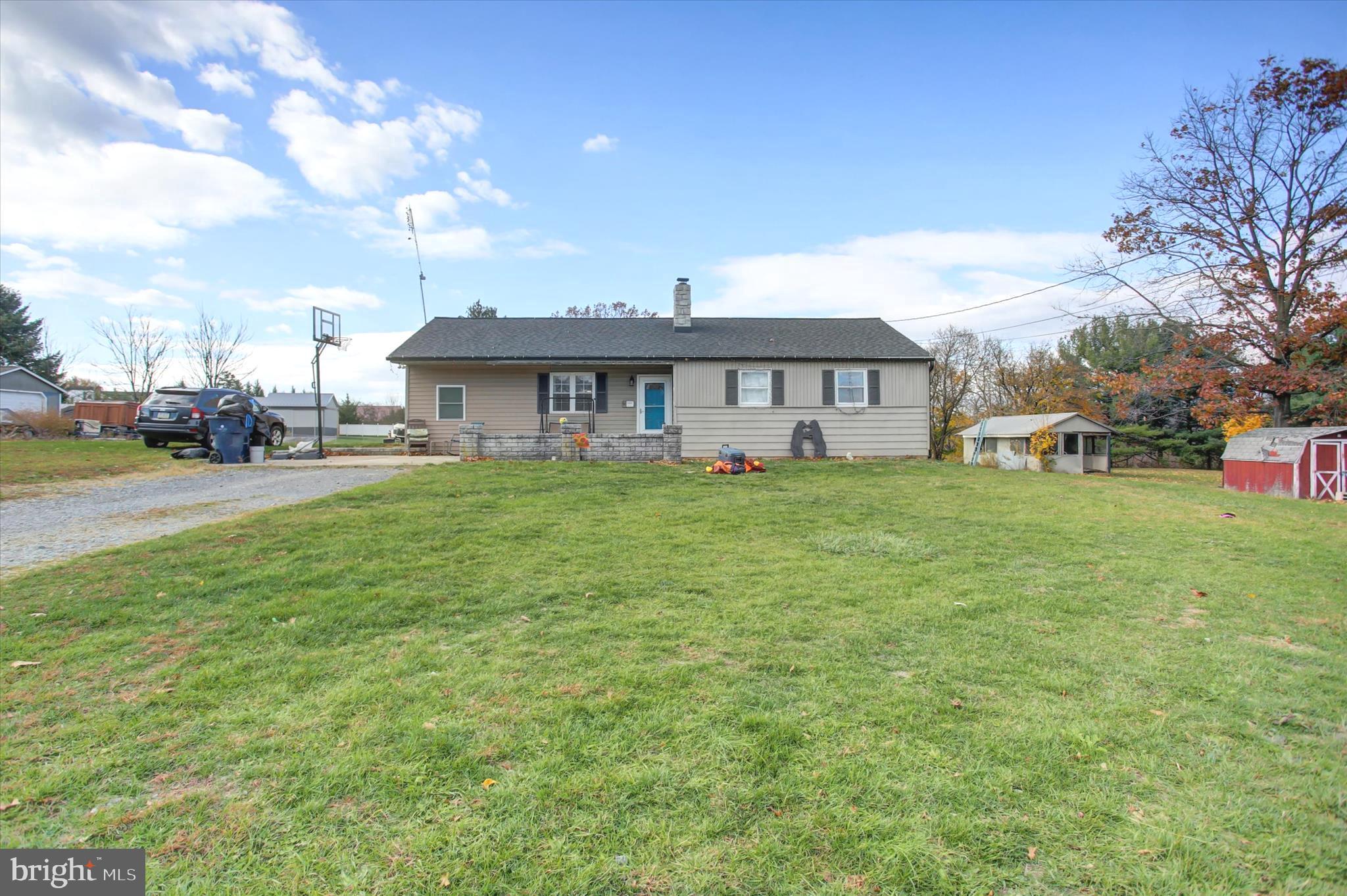 2688 Rocky Spring Road Chambersburg, PA 17201 - Photo 3 of 36 a view of a house with a big yard and large trees