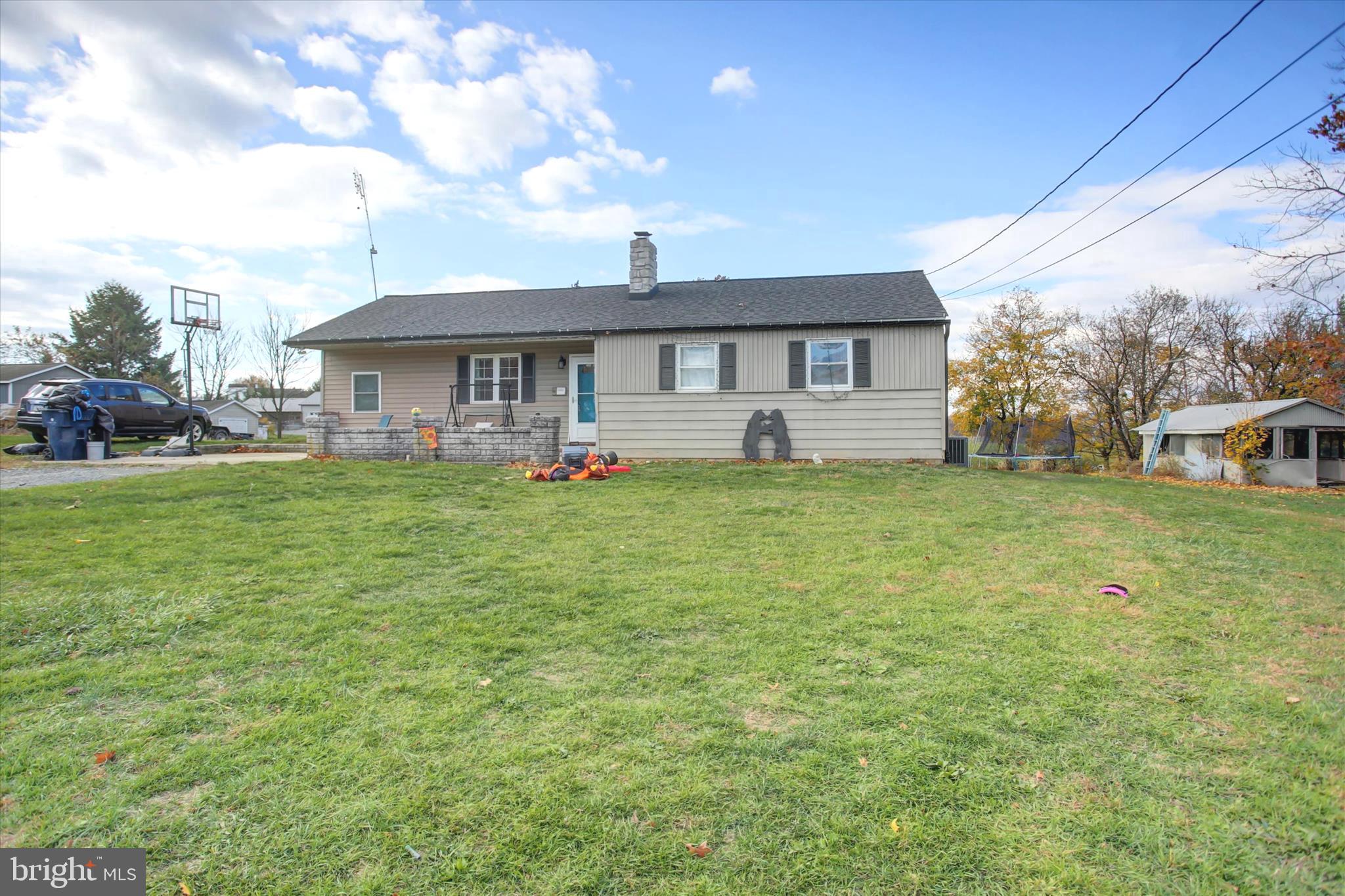 2688 Rocky Spring Road Chambersburg, PA 17201 - Photo 4 of 36 a view of a house with a big yard and large trees