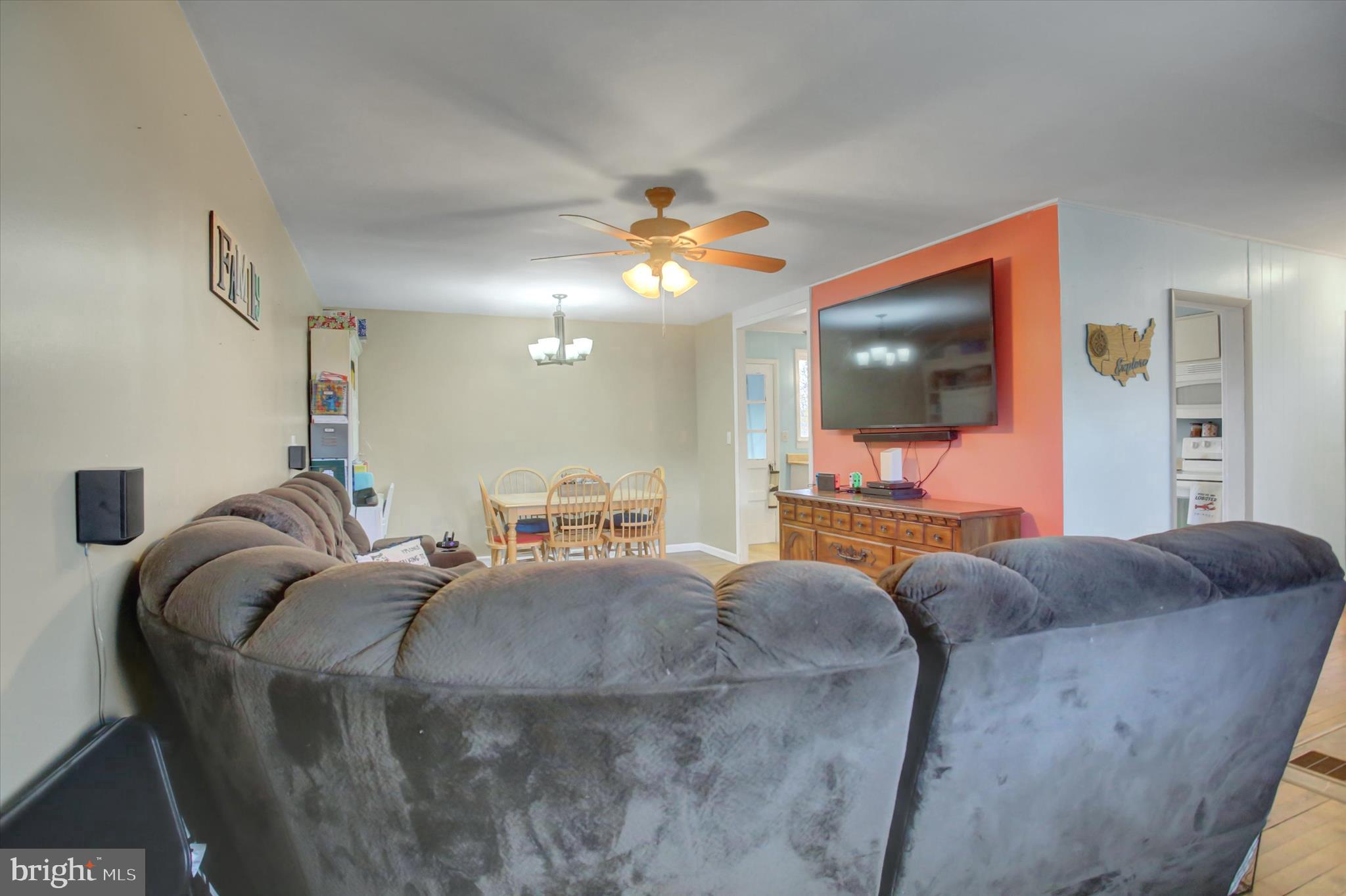 2688 Rocky Spring Road Chambersburg, PA 17201 - Photo 7 of 36 a living room with furniture a flat screen tv and a chandelier