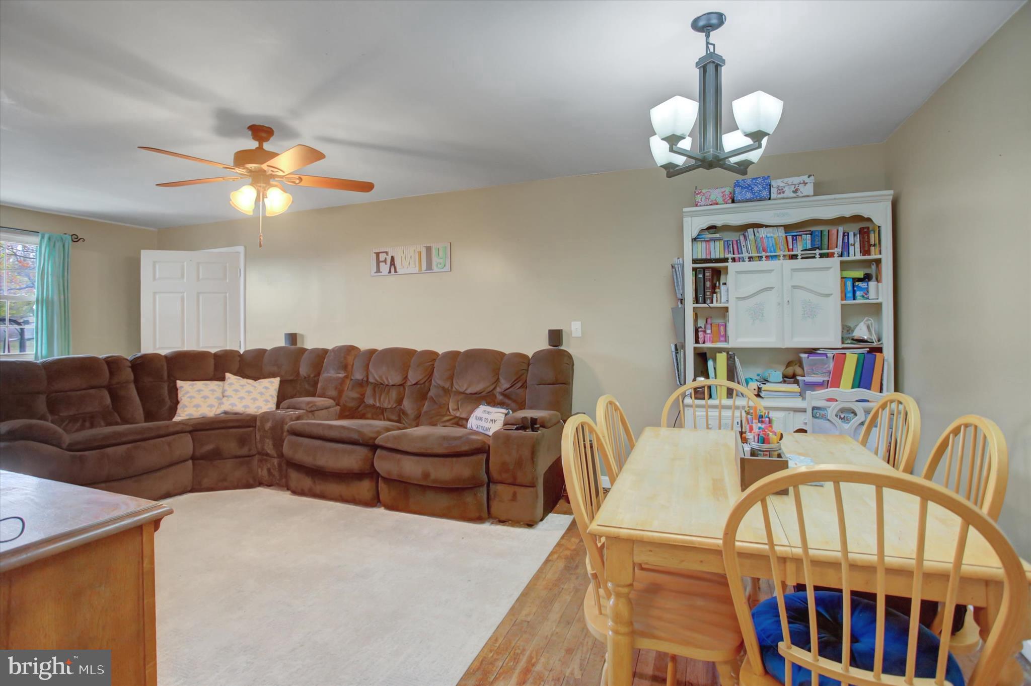 2688 Rocky Spring Road Chambersburg, PA 17201 - Photo 8 of 36 a living room with furniture a chandelier and a dining table