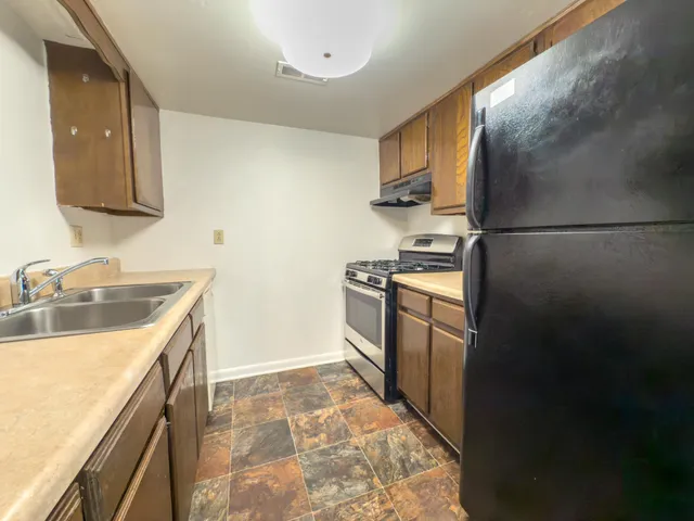 a kitchen with a sink stove and refrigerator