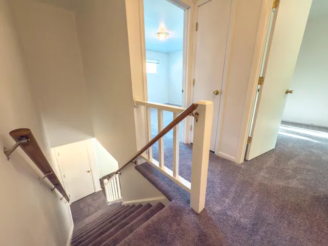 a view of a hallway with staircase