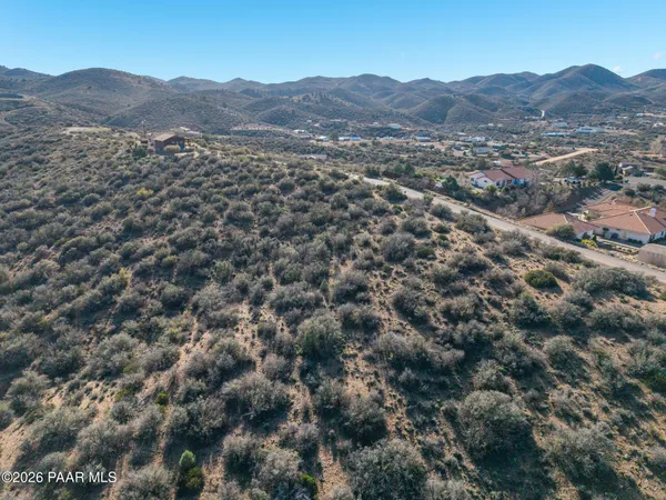 a view of a mountain with a green field