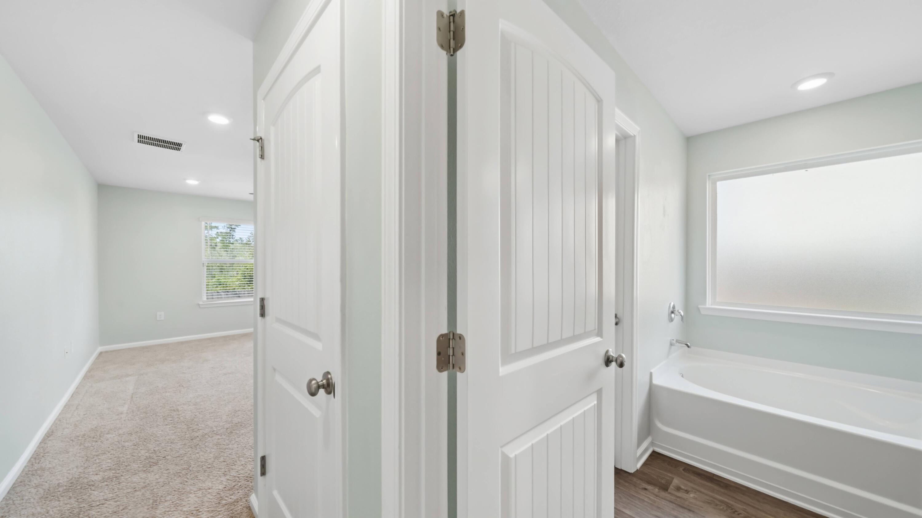 3927 Alva Thomas Road Panama City, FL 32404 - Photo 11 of 46 a bathroom with a bathtub and a shower