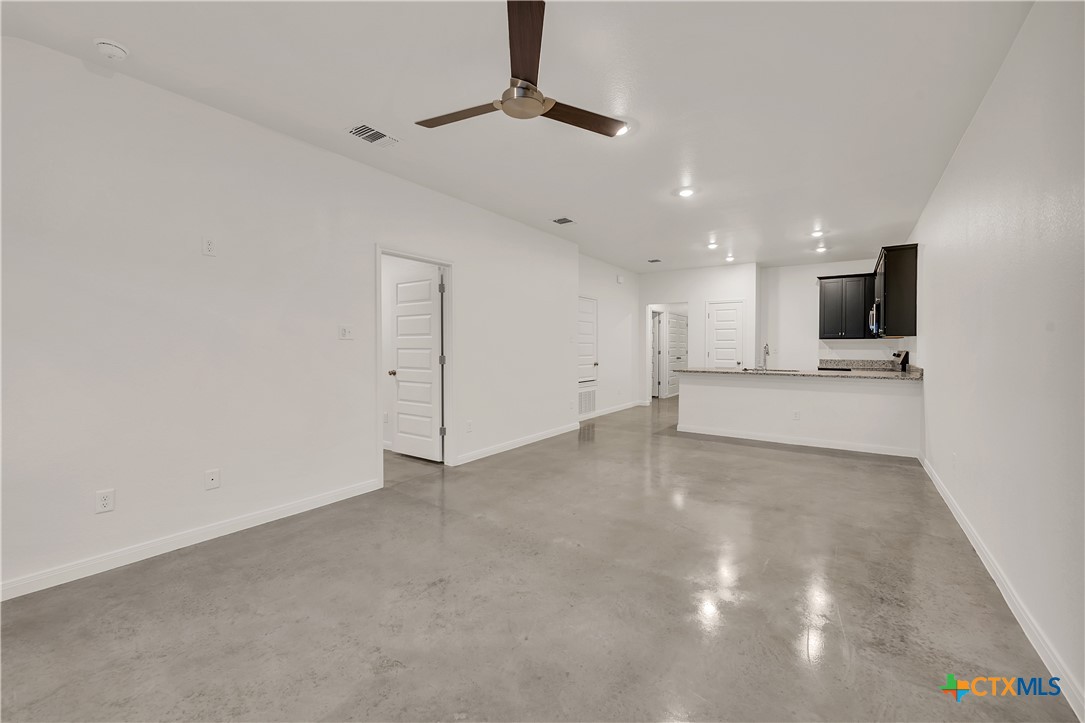 903 Wax Myrtle Court, Unit B Killeen, TX 76543 - Photo 2 of 13 a view of an empty room with kitchen and a window