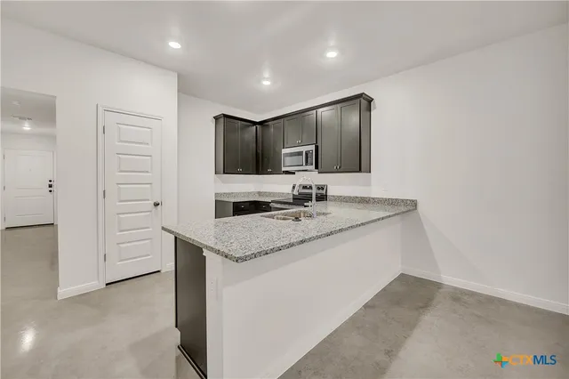 a kitchen with a sink stove and refrigerator