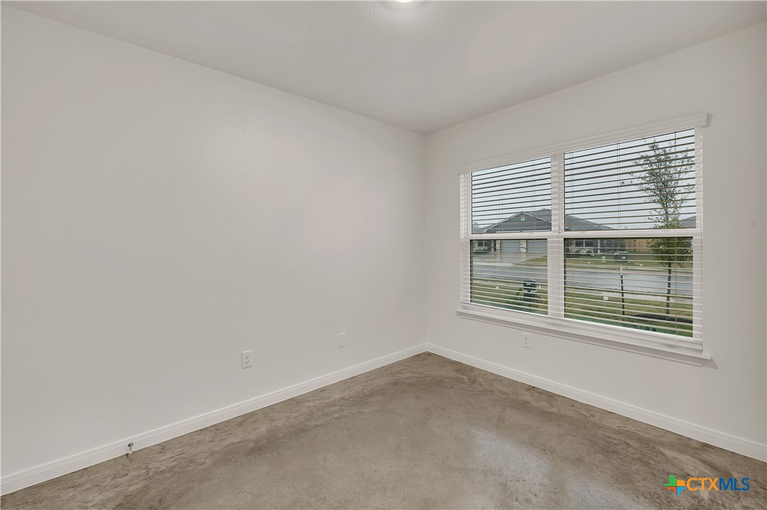 903 Wax Myrtle Court, Unit B Killeen, TX 76543 - Photo 6 of 13 a view of an empty room with a window