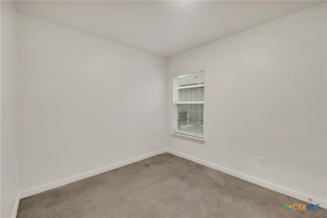 903 Wax Myrtle Court, Unit B Killeen, TX 76543 - Photo 9 of 13 a view of an empty room with a window