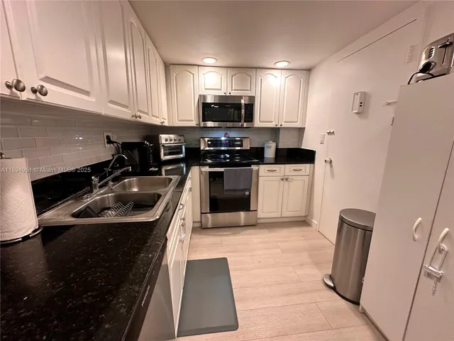 a white toilet sitting next to a white toilet and sink