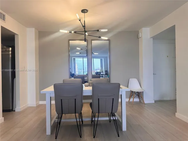 a bathroom with a toilet a sink a mirror and shower