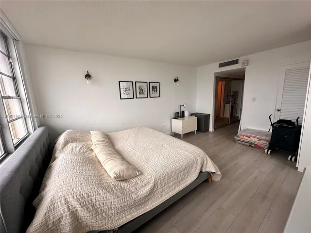 a view of a hallway with wooden floor and stairs