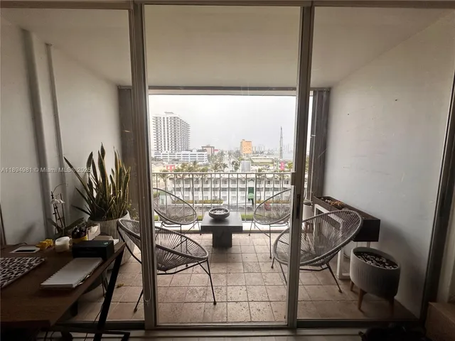 a view of a living room with furniture and a floor to ceiling window
