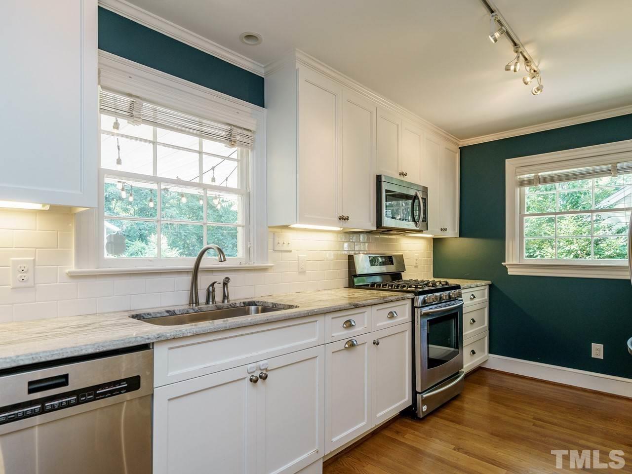 1703 Fairview Road Raleigh, NC 27608 - Photo 11 of 30 a kitchen with a stove a sink and a window