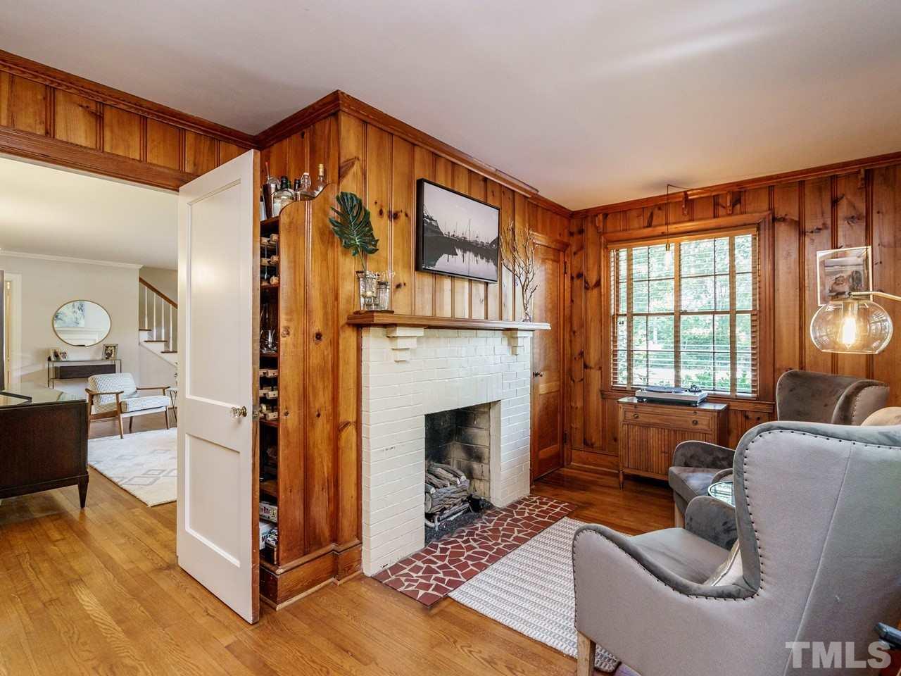 1703 Fairview Road Raleigh, NC 27608 - Photo 14 of 30 a living room with furniture a fireplace and a large window
