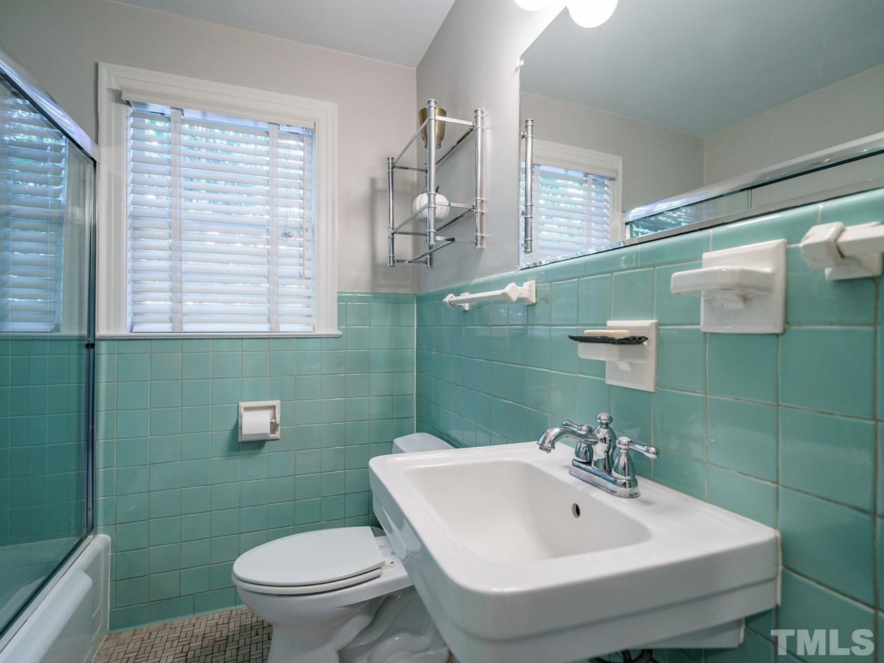 1703 Fairview Road Raleigh, NC 27608 - Photo 16 of 30 a bathroom with a sink a toilet and mirror