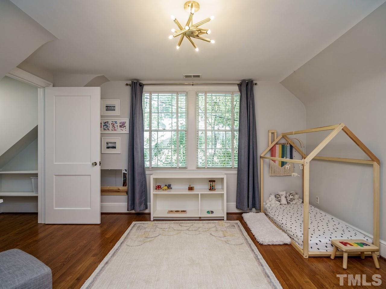 1703 Fairview Road Raleigh, NC 27608 - Photo 22 of 30 a spacious bedroom with a bed and a window