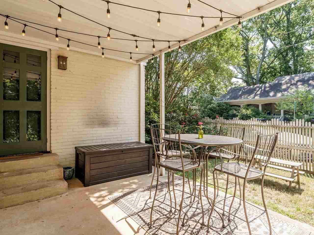 1703 Fairview Road Raleigh, NC 27608 - Photo 26 of 30 a view of a patio with a dining table and chairs with wooden floor
