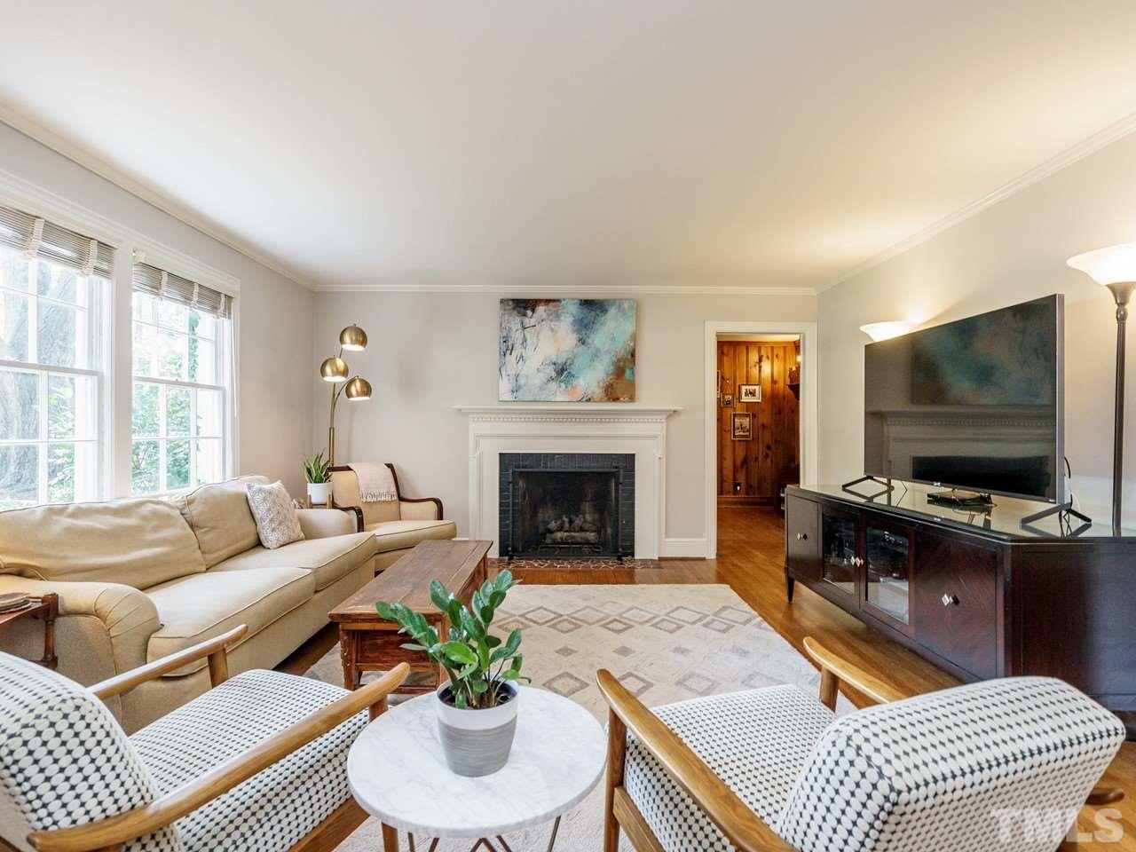 1703 Fairview Road Raleigh, NC 27608 - Photo 4 of 30 a living room with furniture a fireplace and a flat screen tv