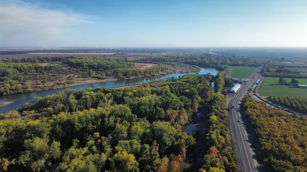 an aerial view of a house with a yard and lake view