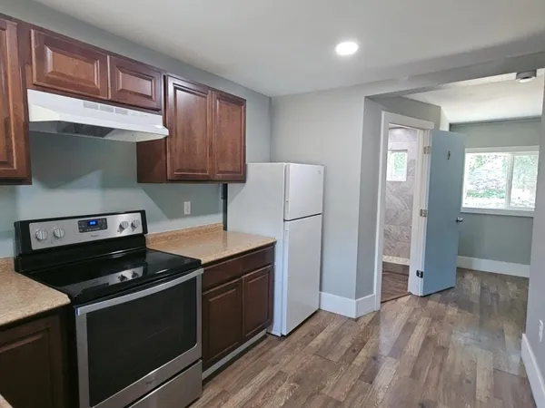 a kitchen with a stove and a refrigerator