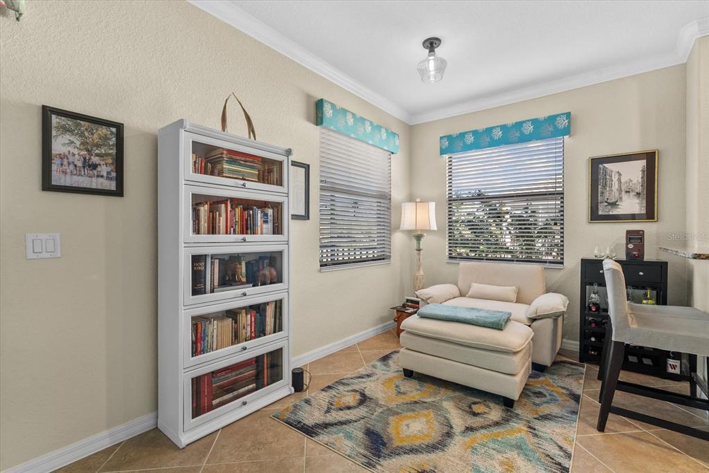 20080 Ragazza Circle, Unit 202 Venice, FL 34293 - Photo 11 of 51 a living room with furniture and a book shelf