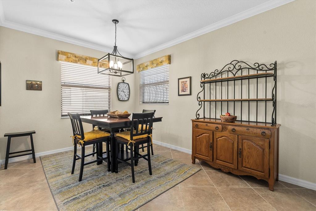 20080 Ragazza Circle, Unit 202 Venice, FL 34293 - Photo 17 of 51 a view of a dining room with furniture window and wooden floor