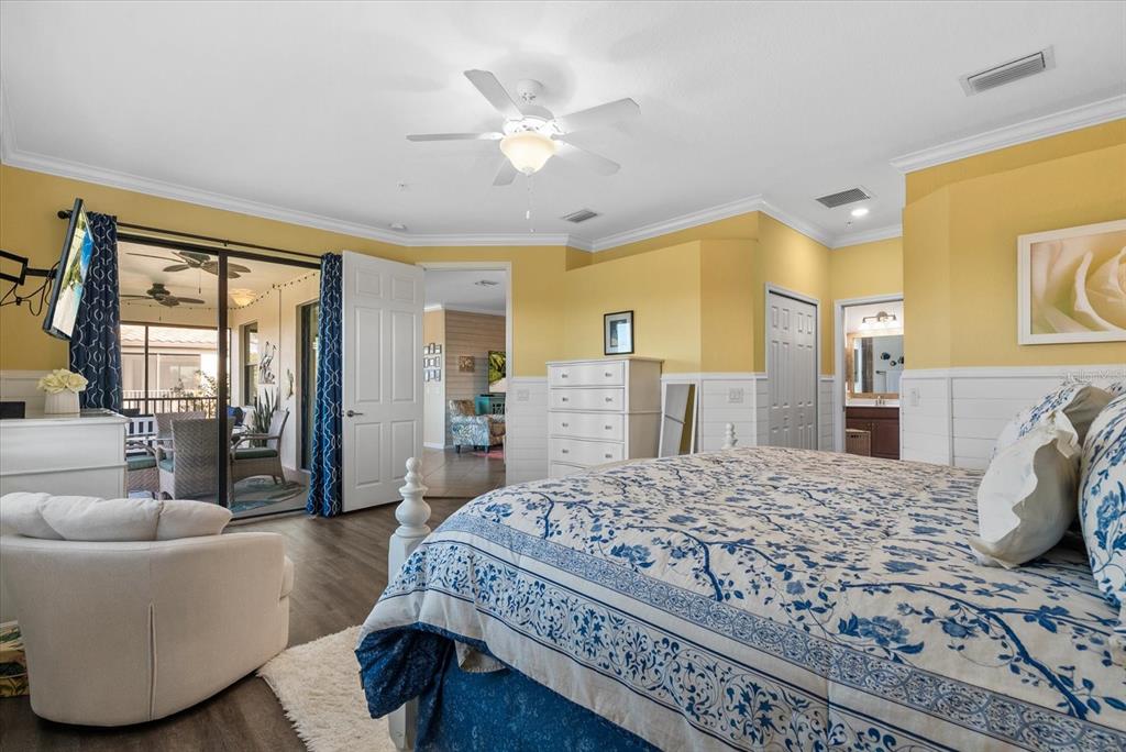 20080 Ragazza Circle, Unit 202 Venice, FL 34293 - Photo 18 of 51 a bedroom with a large bed and a couch