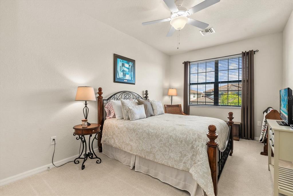 20080 Ragazza Circle, Unit 202 Venice, FL 34293 - Photo 22 of 51 a bedroom with a bed and a table