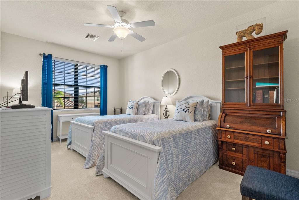 20080 Ragazza Circle, Unit 202 Venice, FL 34293 - Photo 23 of 51 a bedroom with a bed and a dresser next to a window