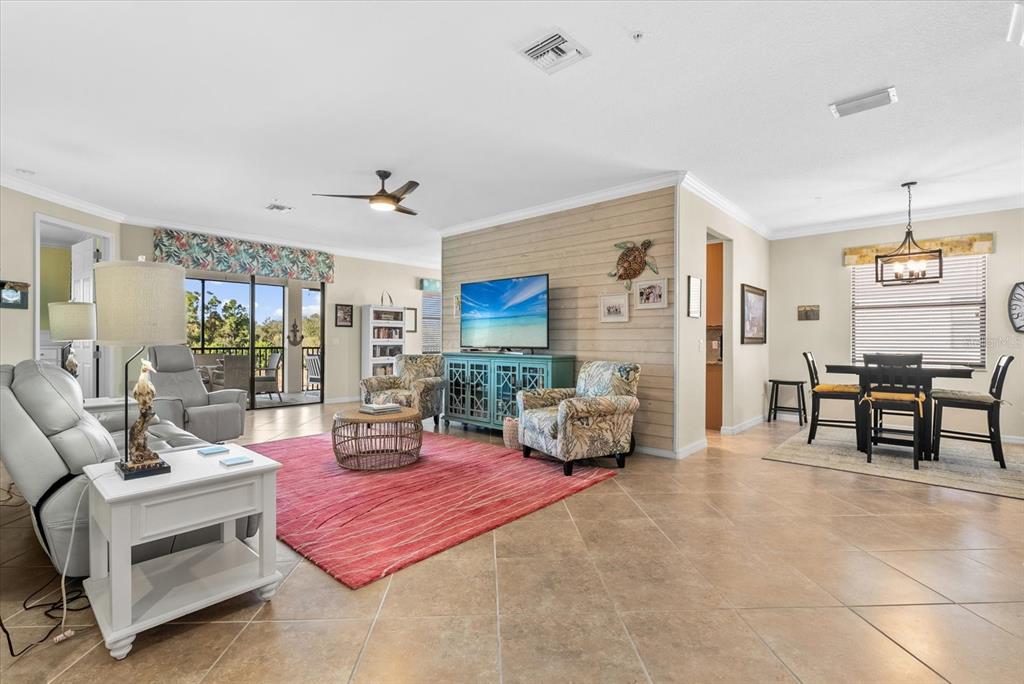 20080 Ragazza Circle, Unit 202 Venice, FL 34293 - Photo 5 of 51 a living room with furniture and a fireplace