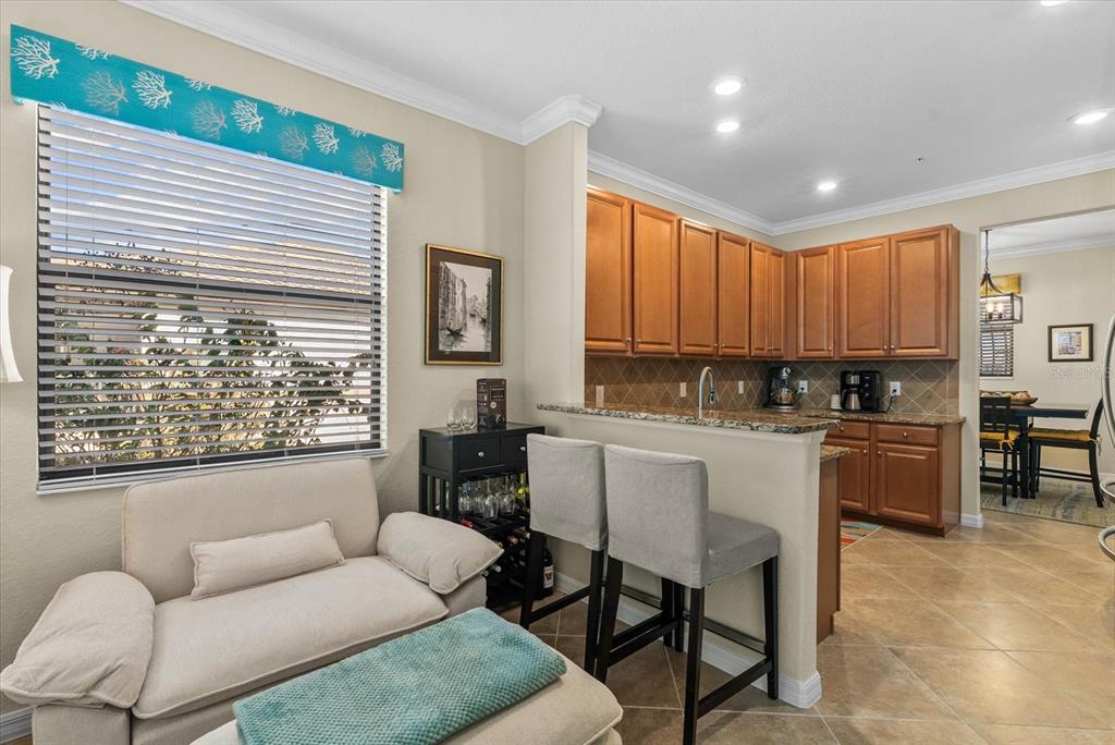 20080 Ragazza Circle, Unit 202 Venice, FL 34293 - Photo 10 of 51 a living room with furniture a large window and kitchen view