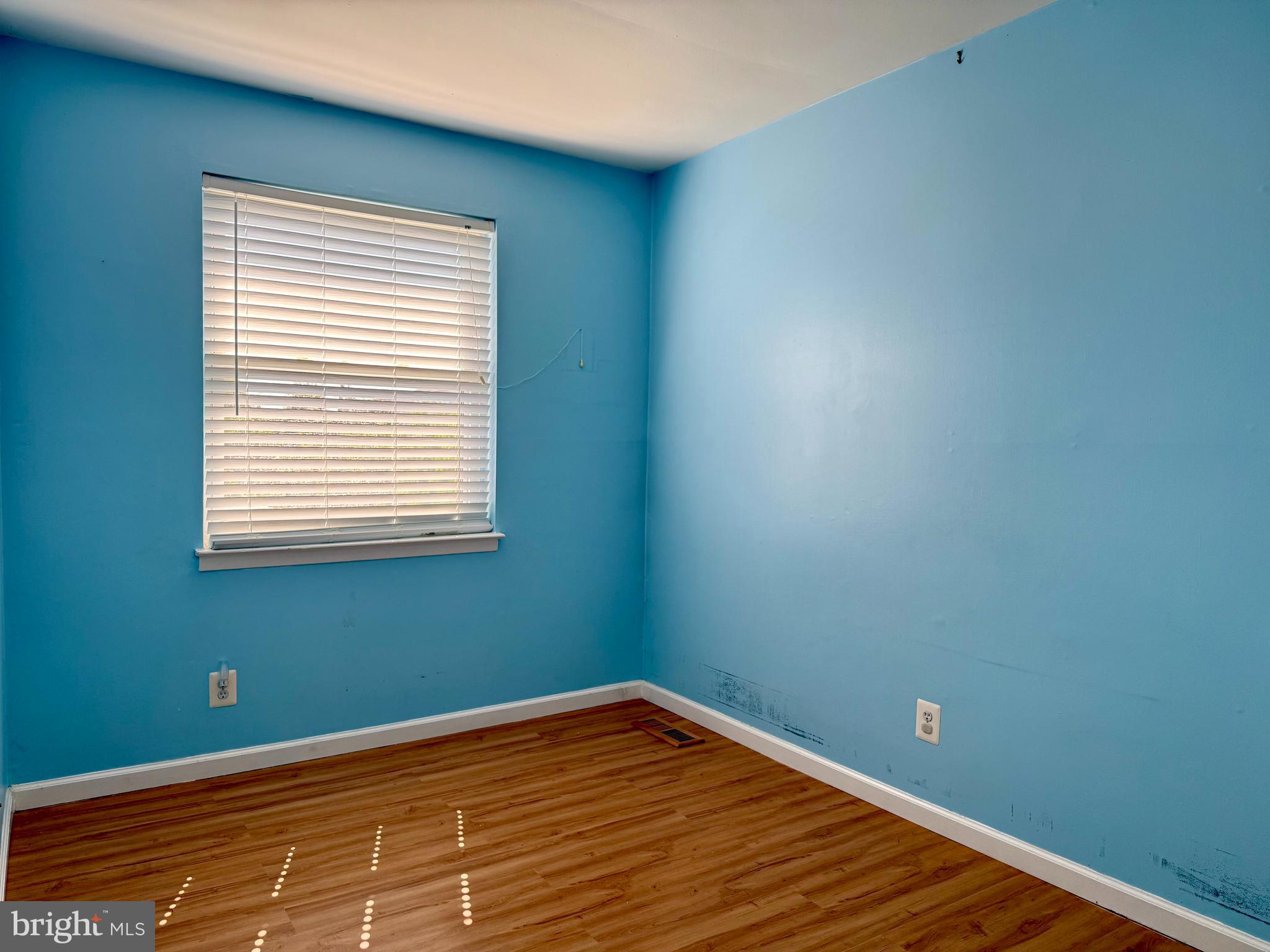 9613 Conmar Road Baltimore, MD 21220 - Photo 11 of 28 a view of a room with wooden floor and a window
