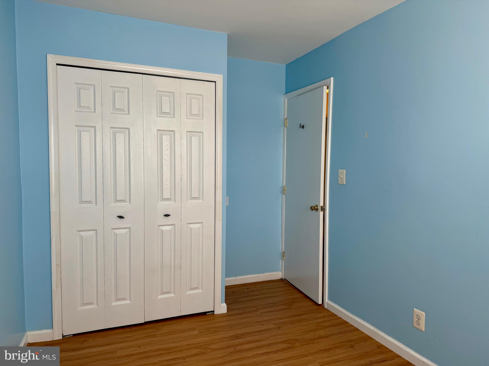 9613 Conmar Road Baltimore, MD 21220 - Photo 12 of 28 a view of an empty room with wooden floor
