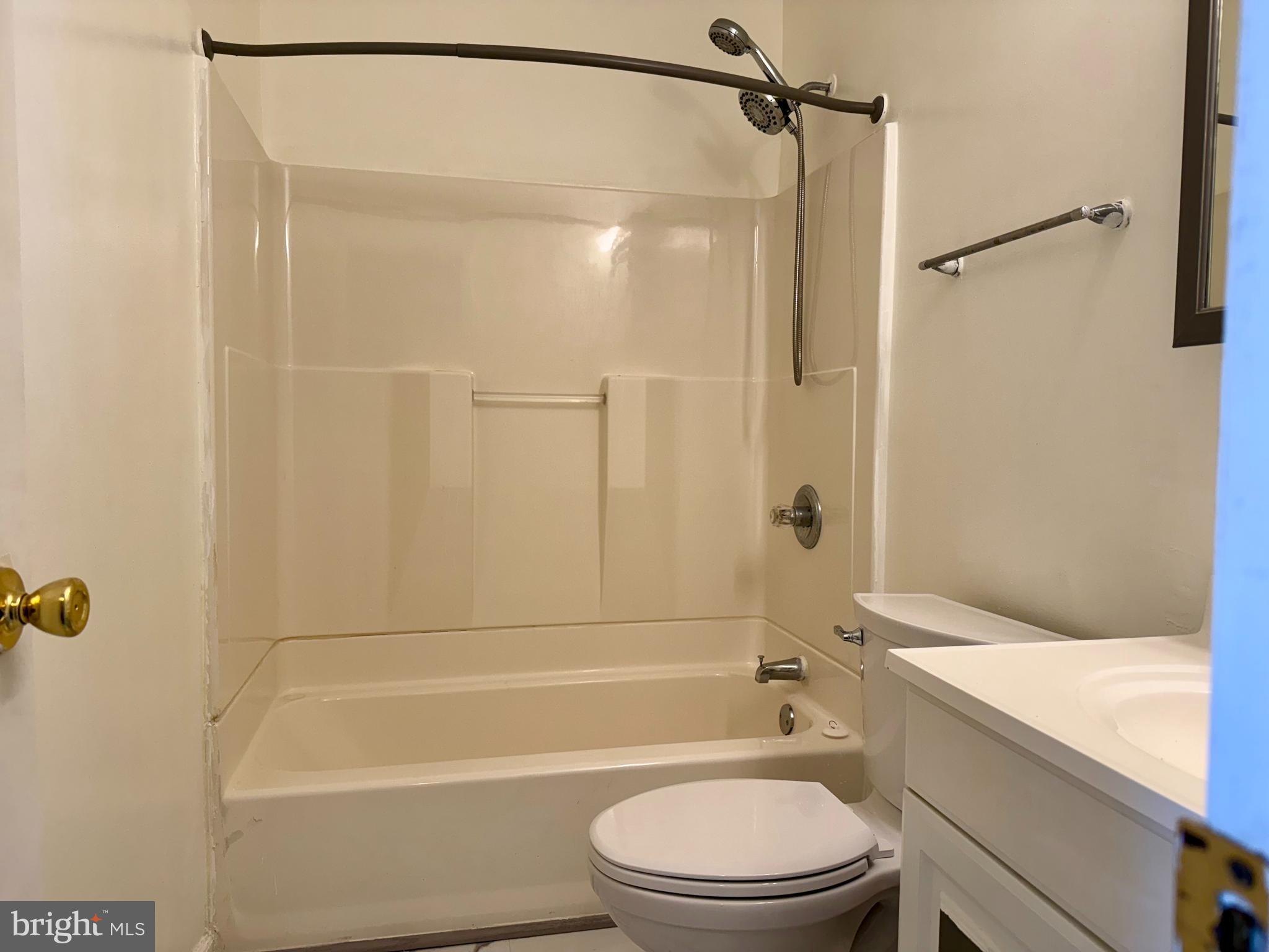 9613 Conmar Road Baltimore, MD 21220 - Photo 18 of 28 a bathroom with a granite countertop bathtub shower sink vanity and toilet