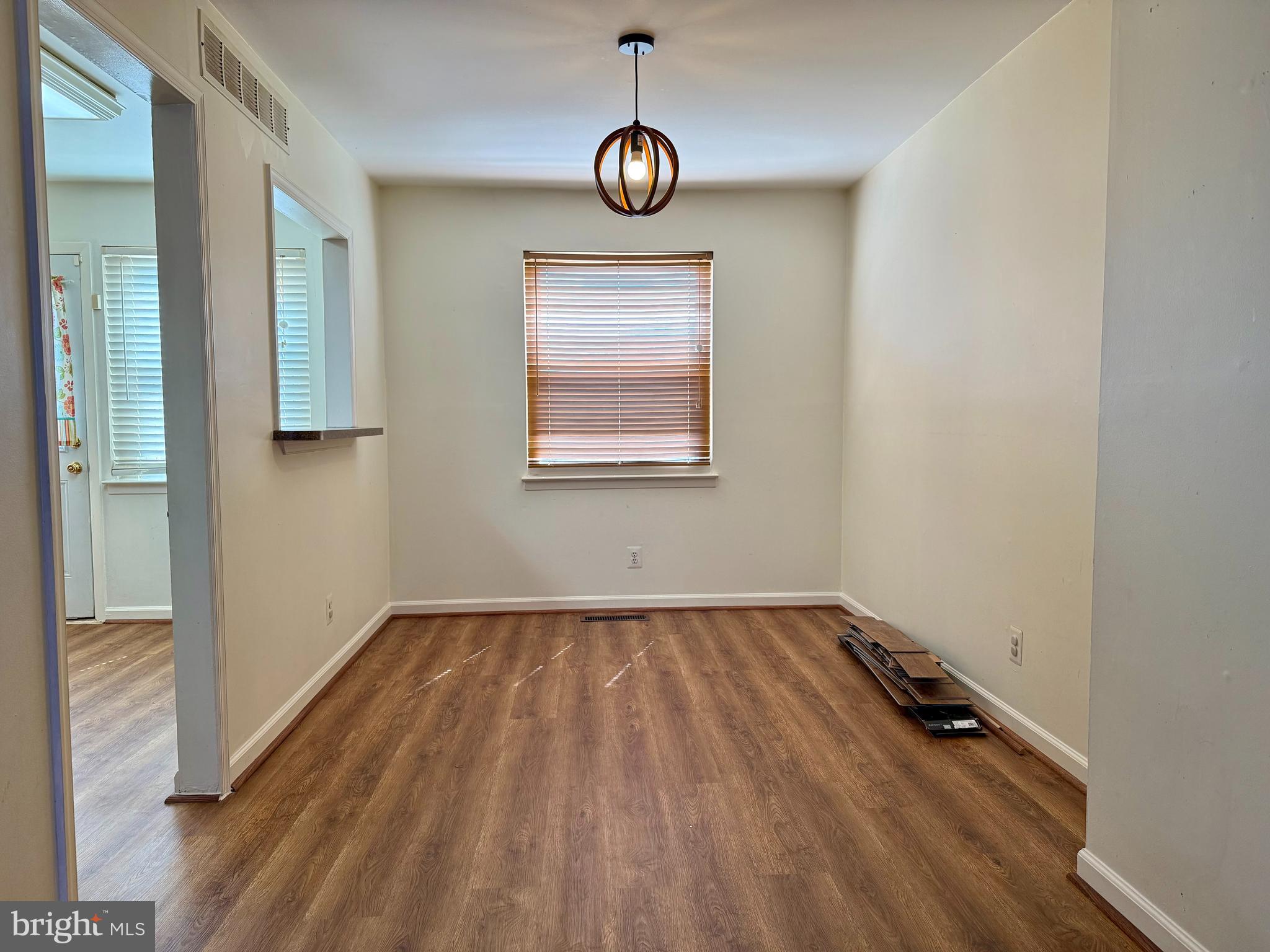 9613 Conmar Road Baltimore, MD 21220 - Photo 5 of 28 a view of an empty room with wooden floor and a window