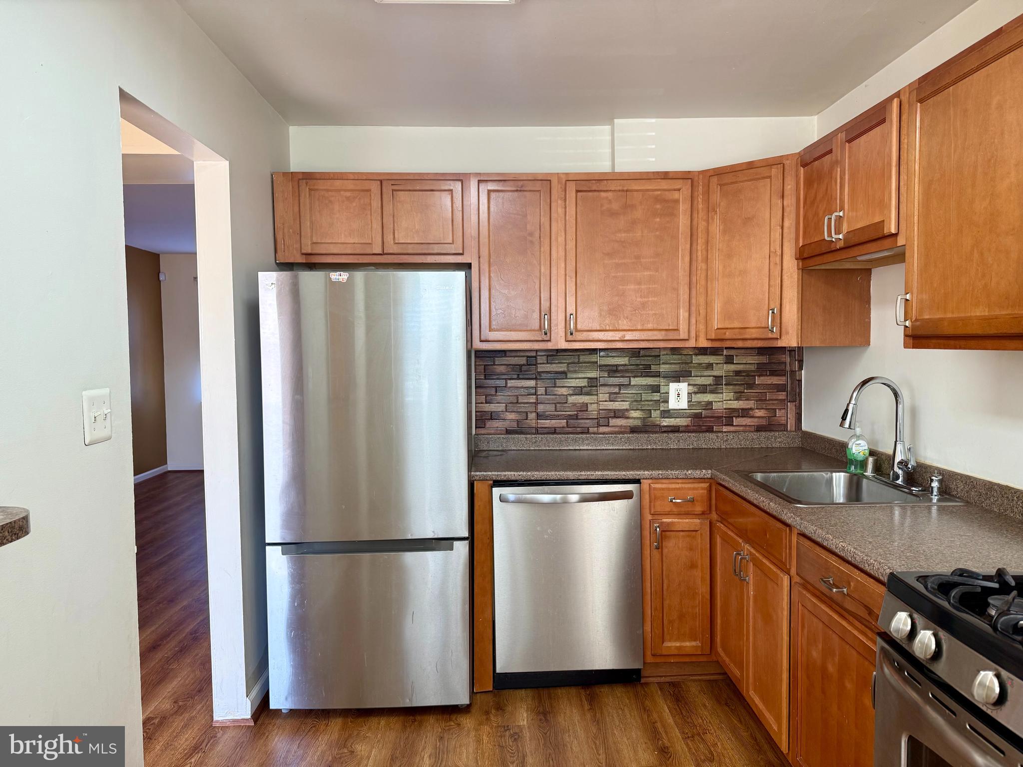 9613 Conmar Road Baltimore, MD 21220 - Photo 6 of 28 a kitchen with a refrigerator sink and cabinets