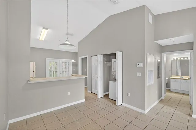 a view of a kitchen with wooden floor and a window